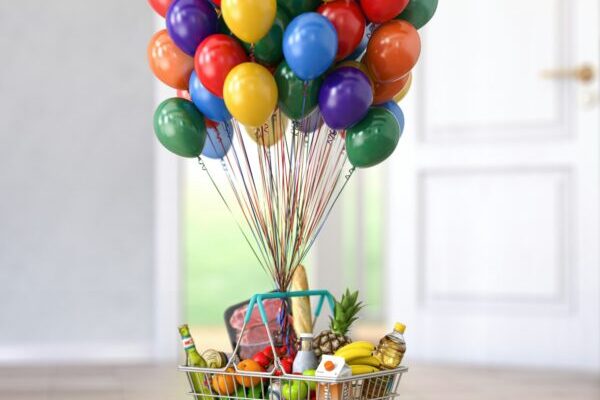 Shopping basket full of food and eats with balloons